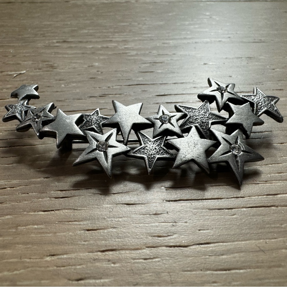 J & J silver tone star brooch